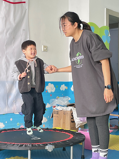 Hengheng enjoys jumping as he works with his occupational therapist